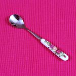 Dessert spoon with flower patterned ceramic handle